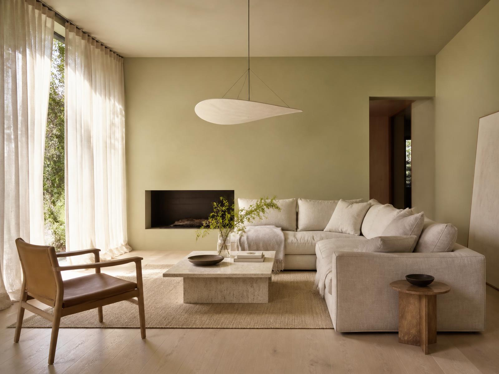 Minimal living room with lime plaster walls, linen seating and travertine table