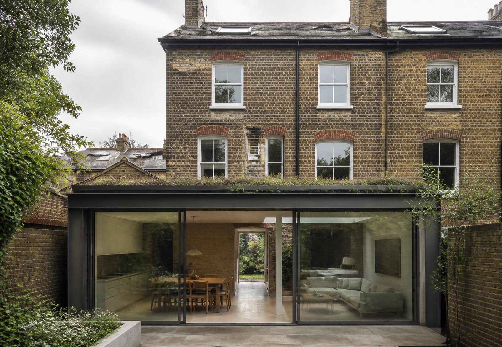 Victorian London brick house with a contemporary glazed extension and green roof